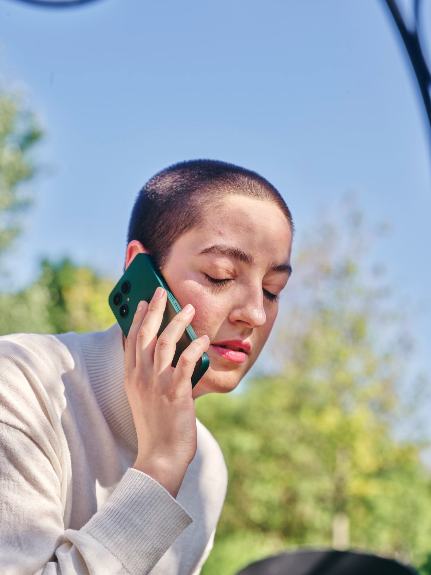 Person holding a phone with closed eyes